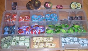 A bunch of cardboard tokens sorted into a small tackle box